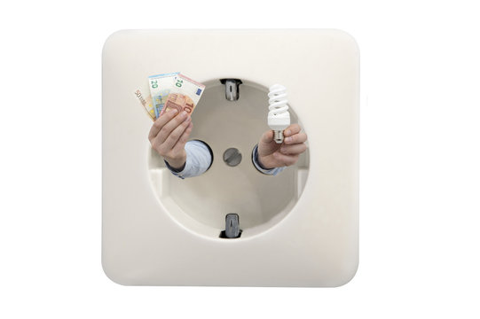 Close up of wall socket with man's hands holding euros and energy efficient light bulb