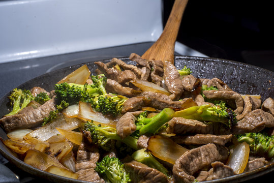 Beef Broccoli And Onion Stirfry Steaming In Pan