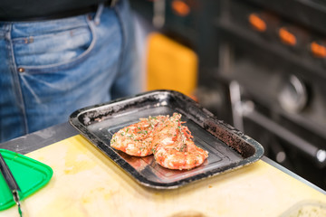 Chef in hotel or restaurant kitchen cooking, only hands.
