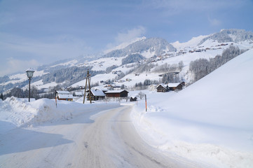Fototapeta na wymiar Snow covered road in an Austrian mountain village