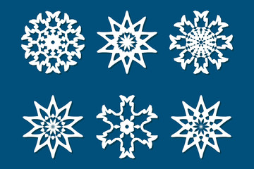 Snowflake set. Laser cut pattern for christmas paper cards, wood carving, paper cutting, design elements, scrapbooking. Collection of different white snowflakes on blue background