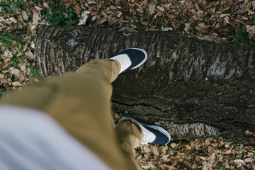 young man legs on a wooden beam