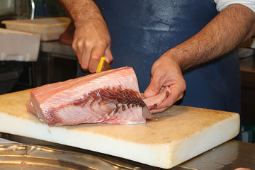 cutting fish fillet in a fish shop