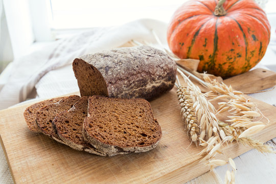 Freshly baked breads with ears and pumpkin. Shallow depth of field. Coloring and processing photo.