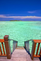 Stairs leading to tropical lagoon.