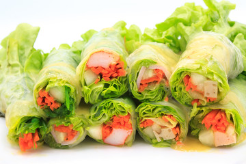 Salad roll with sauce on the disk, isolated picture