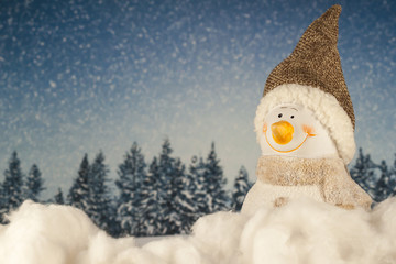 Christmas toy snowman in the forest 