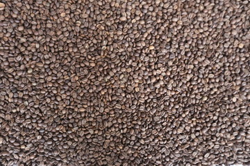 Roasted brown coffee beans background, above view. Coffee beans texture