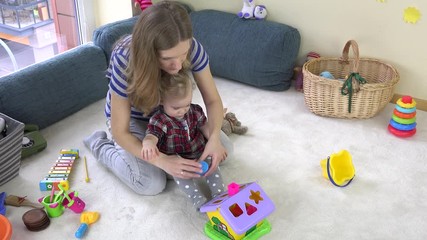 young loving mom teaches daughter girl to distinguish object shapes. - Powered by Adobe