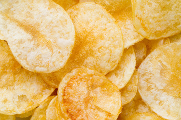Close up potato chips on wood top view background.