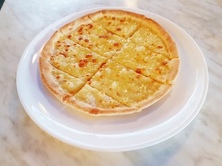 Simple freshly baked and ready to eat hot sliced cheese pizza pie