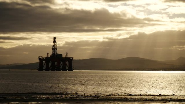 Silhouette of Semi Submersible Oil Rig and Big Boat at Cromarty Firth in Invergordon, Scotland
