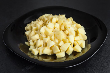 sliced potatoes on black plate