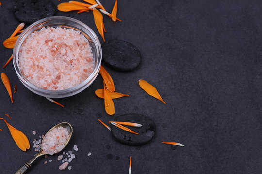 Salt scrub or body polish concept. Spa background. Volcanic rocks and pentals. Relaxation, body care treatment, spa, wellness concept, copy space