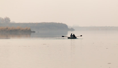 fishing boat on the lake at sunset