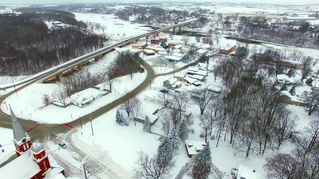 Small town America neighborhood under heavy snowfall, beautiful ranch homes.
