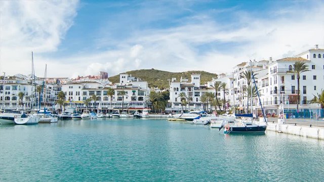 Puerto de la Duquesa Marina in Manilva Spain with Yachts and Boats in the Harbour Surrounded by Vacation Apartments and Restaurants