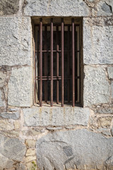 Fototapeta na wymiar Old Stone Jail House Window with bars