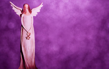 Christmas angel on a purple bokeh background