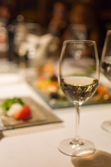 Glass of white wine on a restaurant table