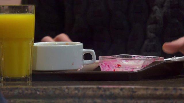 Man eats in a restaurant and wipes his hands with a napkin