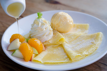 Mixed fruit crape with ice cream and honey.
