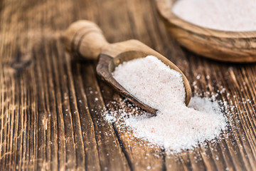Himalayan Salt on wooden background (selective focus)