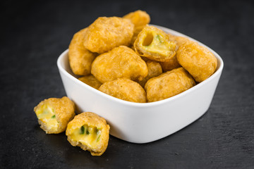 Cheese Nuggets (with Chilis) on a vintage slate slab (selective