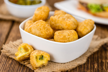Chili Cheese Nuggets (selective focus) on vintage wooden backgro