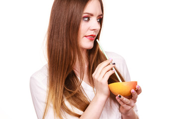 Woman holds grapefruit drinking juice from fruit