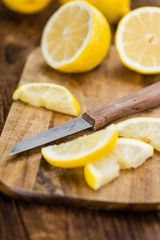 Lemon (sliced) on wooden background (selective focus)