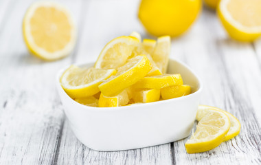Lemon (sliced) on wooden background (selective focus)