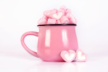the marshmallow heart shape in cup on pink background with love