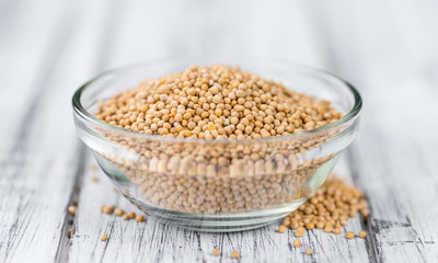 Mustard Seeds on vintage wooden background