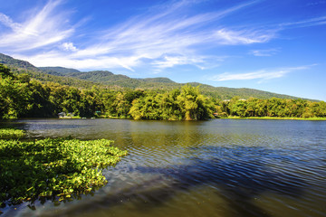 Obraz na płótnie Canvas Reservoir under blue sky with a mountain backdrop