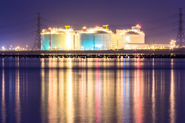 Fototapeta na wymiar petrochemical industrial oil tanks in a refinery at twilight