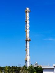 Refinery tower in petrochemical industrial plant with cloudy sky