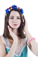 Portrait of a girl in a wreath of flowers