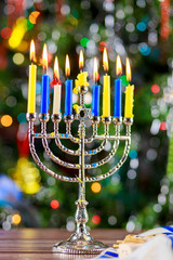 Happy Hanukkah. Low key image of jewish holiday with menorah the night view out focus