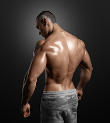 Fototapeta premium Muscled male model showing his back