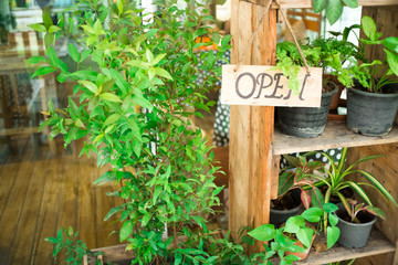 vintage Wooden board sign that says Open  in front of the door at restaurant and coffee shop .