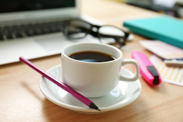 Cup of coffee on office table, close up