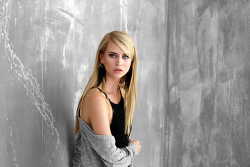 Fototapeta premium Portrait of pretty young woman against grunge background