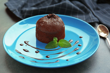 Chocolate fondant with mint on plate