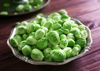 Plate with brussels sprouts on wooden table