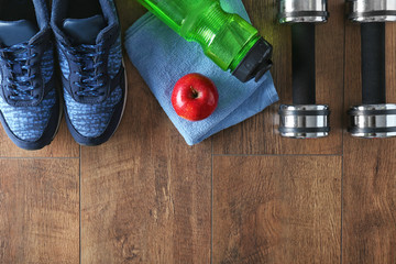 Fitness equipment on wooden background