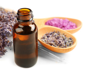Essential oil, lavender and sea salt on white background