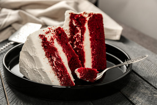 Slices Of Delicious Red Velvet Cake On Black Plate