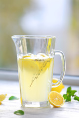 Cold fresh lemonade on windowsill
