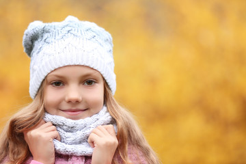 Portrait of cute girl outdoors on blurred background